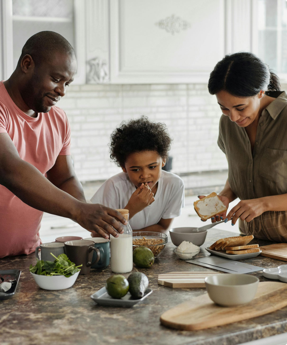 mix race family making dinner at the counter