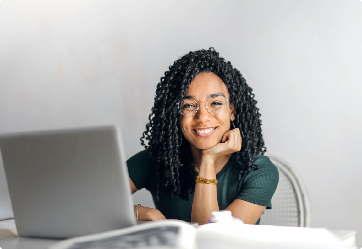 Woman working at a laptop smiling