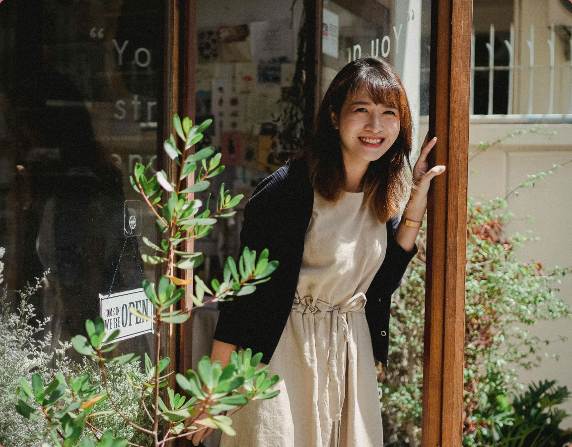 woman opening the door of her store